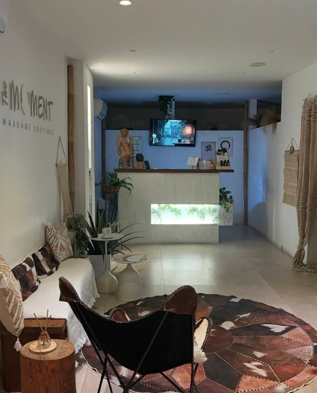 The Moment reception and waiting area in Koukaki with the venue name on the wall